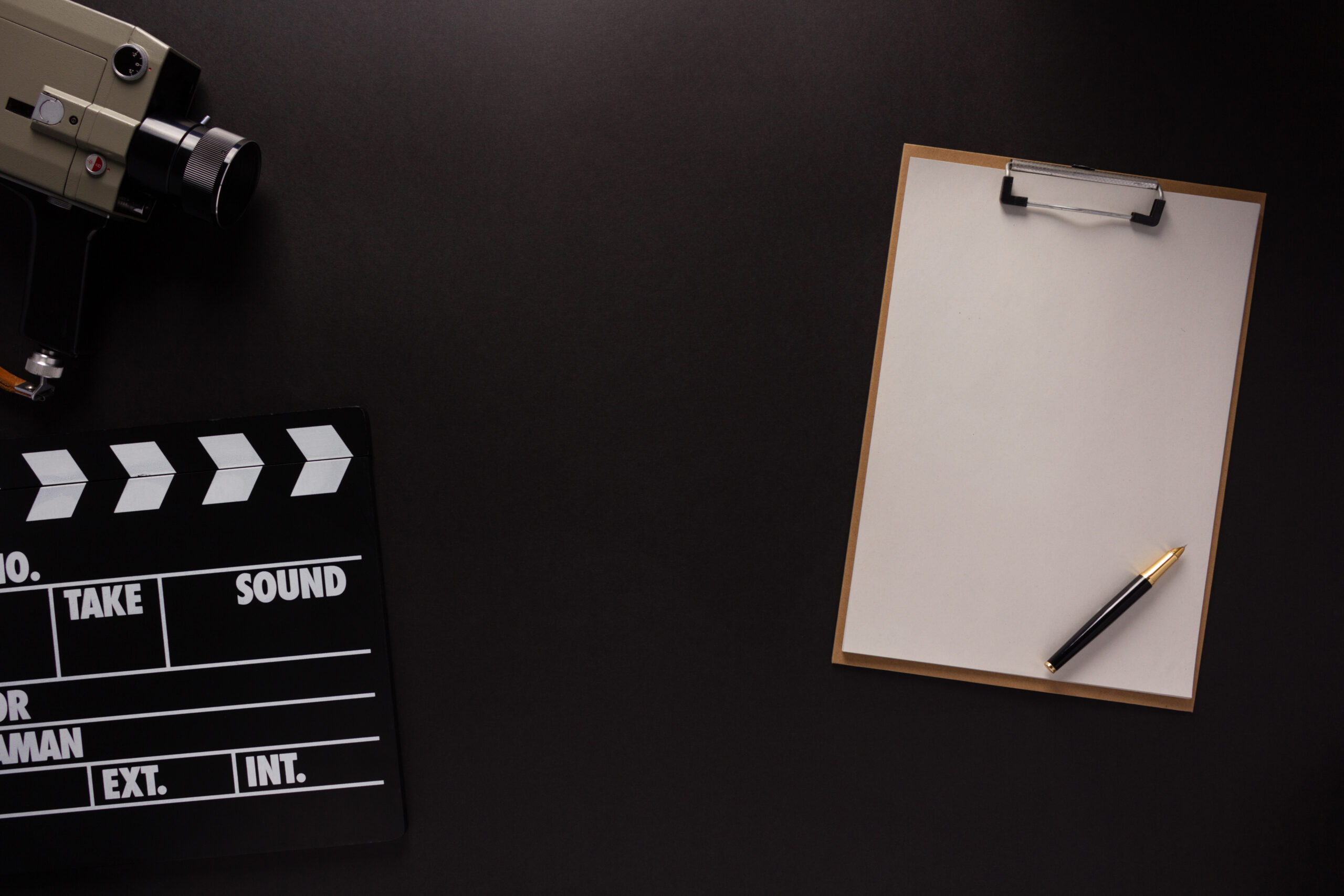 Clapboard and paper at black background texture. Movie idea concept